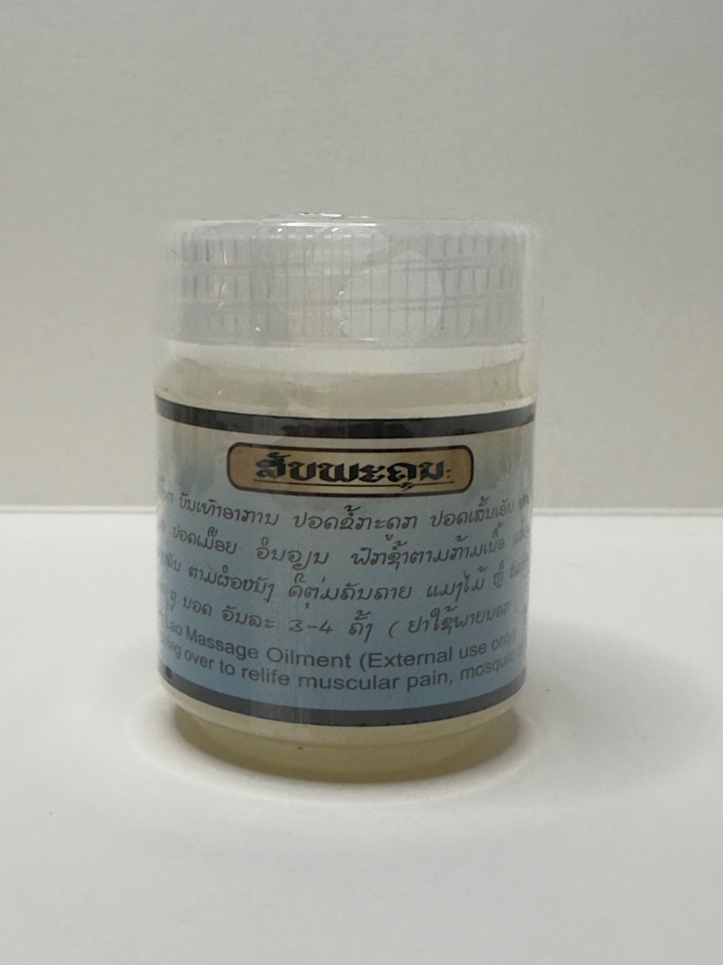 Jar of Lao Herbal massage oil Kanoukham Peppermint Ointment with a label on a white background, usage instructions in Laos