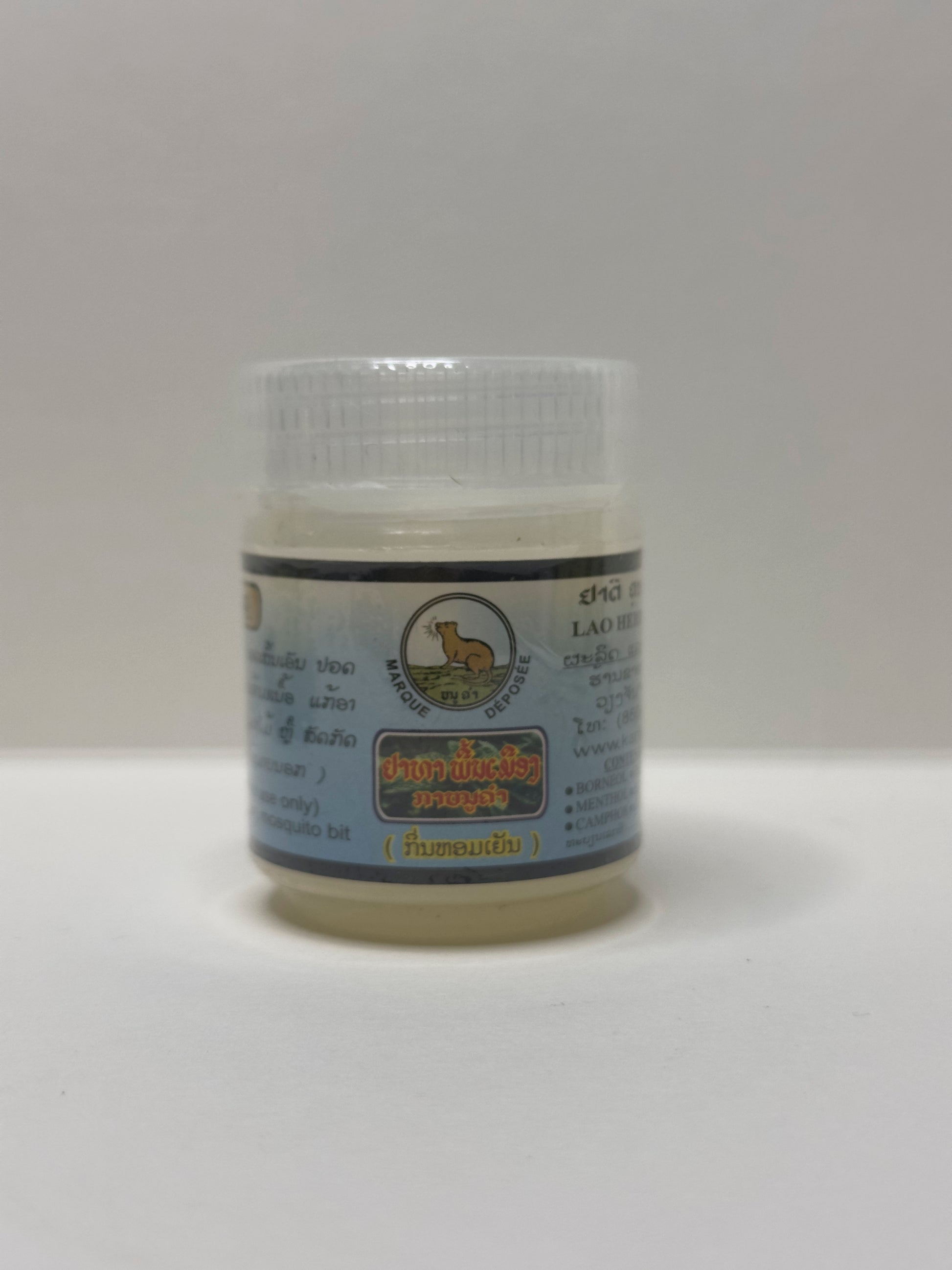 Jar of Lao Herbal Remedy Kanoukham Peppermint balm with a label on a white background