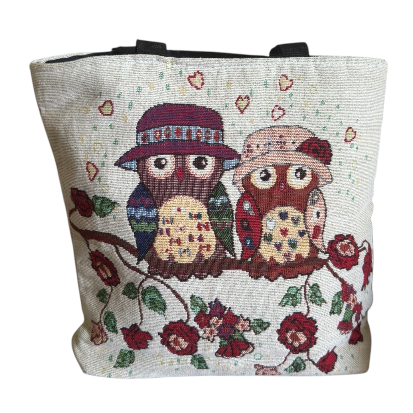 Tote bag with embroidered design of two owls on a branch with flowers and hearts.