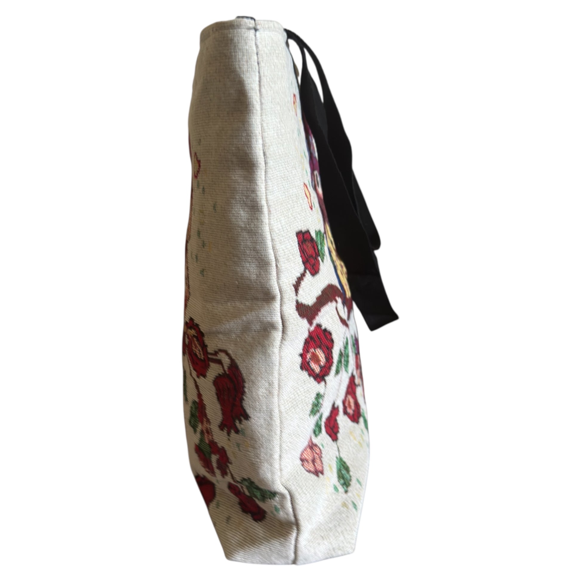Floral embroidered bag with a strap on a white background